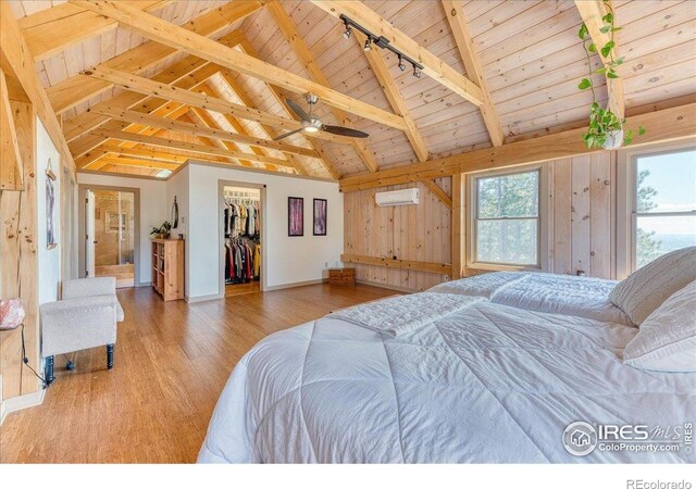 1057 Reed Ranch Rd, Boulder, CO 80302 - bedroom with wooden ceiling, wood finished floors, an AC wall unit, baseboards, and beam ceiling