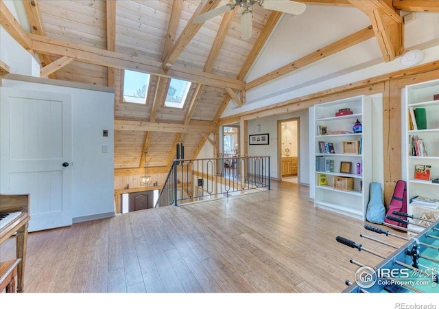 1057 Reed Ranch Rd, Boulder, CO 80302 - recreation room featuring a skylight, wooden ceiling, a ceiling fan, wood finished floors, and wooden walls