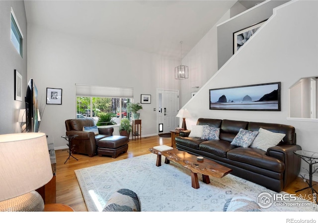 641 Yukon Ct, Windsor, CO 80550 - living room with high vaulted ceiling, wood finished floors, a chandelier, and baseboards