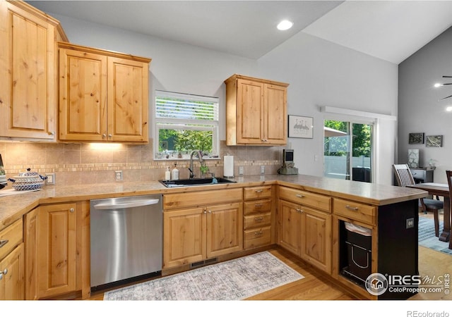 641 Yukon Ct, Windsor, CO 80550 - kitchen with stainless steel dishwasher, a sink, light countertops, plenty of natural light, and high vaulted ceiling
