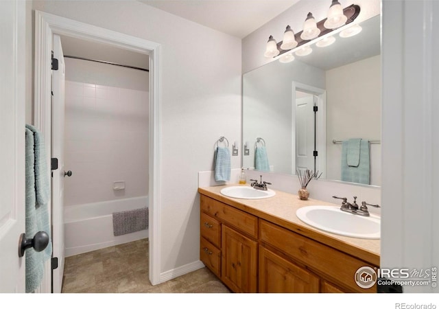 641 Yukon Ct, Windsor, CO 80550 - full bathroom featuring double vanity, tub / shower combination, and baseboards