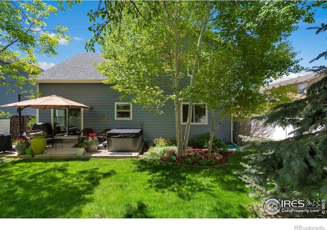 641 Yukon Ct, Windsor, CO 80550 - back of house with a hot tub, a patio area, and a shingled roof