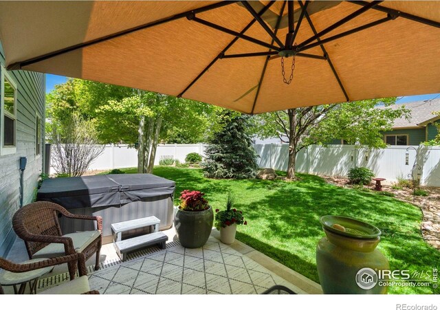 641 Yukon Ct, Windsor, CO 80550 - view of patio featuring a hot tub