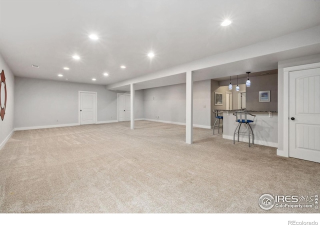 finished below grade area featuring carpet flooring, recessed lighting, and baseboards