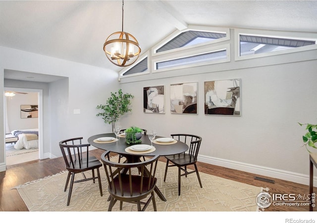 dining room featuring a chandelier, wood finished floors, and baseboards