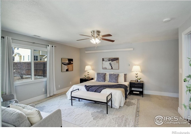 bedroom featuring baseboards, carpet flooring, and ceiling fan