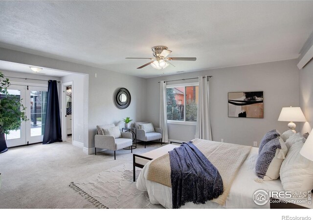 carpeted bedroom with multiple windows, access to exterior, french doors, and baseboards