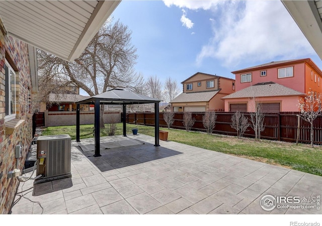 view of patio featuring central air condition unit and a gazebo