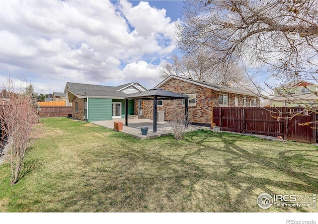 rear view of property with a patio area, brick siding, and a gazebo