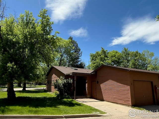 1700 W Mountain Ave Unit 1, Fort Collins, CO 80521 - view of front of home with a garage, a front yard, and driveway
