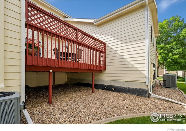 view of property exterior featuring central AC unit and a wooden deck
