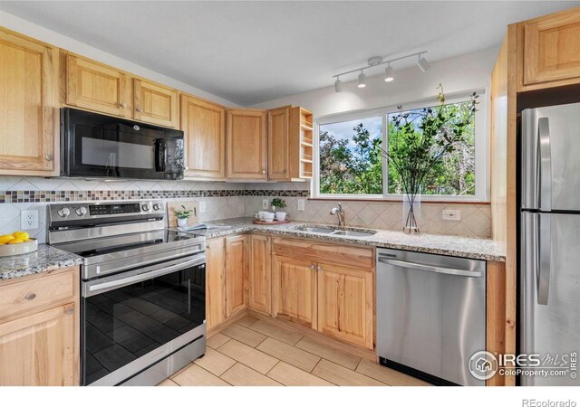 3193 Redstone Ln Unit B6, Boulder, CO 80305 - kitchen with stainless steel appliances, a sink, decorative backsplash, and light stone countertops