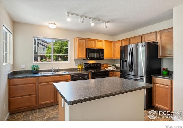 14300 Waterside Ln Unit V1, Broomfield, CO 80023 - kitchen with black appliances, a sink, dark countertops, a kitchen island, and baseboards