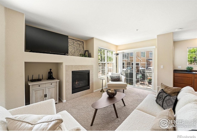 14300 Waterside Ln Unit V1, Broomfield, CO 80023 - carpeted living area with a tiled fireplace, plenty of natural light, and baseboards