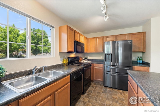 14300 Waterside Ln Unit V1, Broomfield, CO 80023 - kitchen featuring black appliances, a sink, dark countertops, and rail lighting