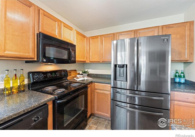 14300 Waterside Ln Unit V1, Broomfield, CO 80023 - kitchen with black appliances and dark countertops