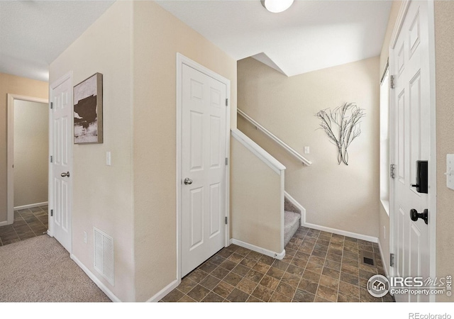14300 Waterside Ln Unit V1, Broomfield, CO 80023 - foyer entrance featuring stone finish flooring, baseboards, and stairs
