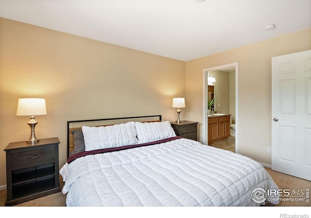 14300 Waterside Ln Unit V1, Broomfield, CO 80023 - bedroom with light colored carpet, baseboards, and ensuite bathroom