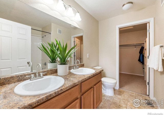 14300 Waterside Ln Unit V1, Broomfield, CO 80023 - bathroom with a spacious closet, toilet, double vanity, and a shower