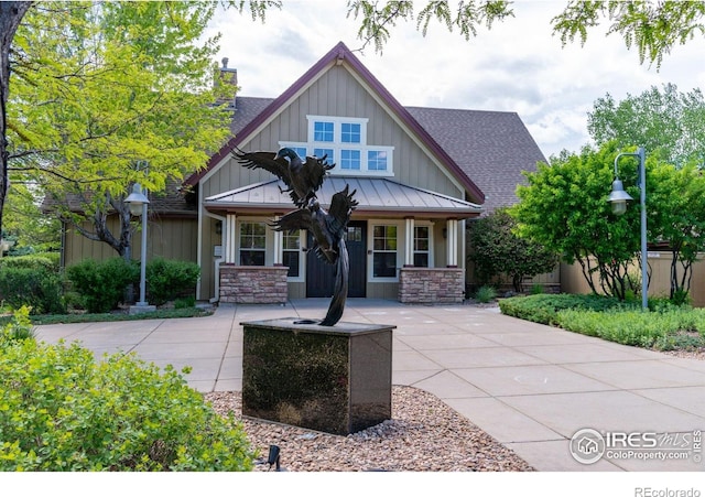 14300 Waterside Ln Unit V1, Broomfield, CO 80023 - craftsman inspired home featuring covered porch, a shingled roof, board and batten siding, and a standing seam roof