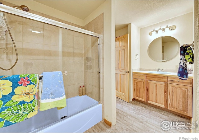 278 Clark Rd, Bailey, CO 80421 - full bathroom with wood finished floors, vanity, and enclosed tub / shower combo