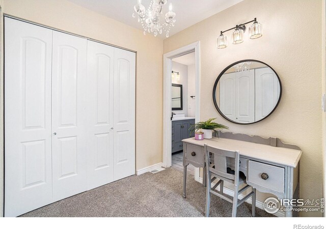 bathroom featuring a chandelier and vanity