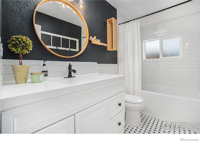 full bathroom featuring toilet, vanity, tile patterned floors, and shower / tub combo