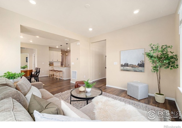 214 Tigercat Way, Fort Collins, CO 80524 - living room with dark wood-type flooring, baseboards, and recessed lighting