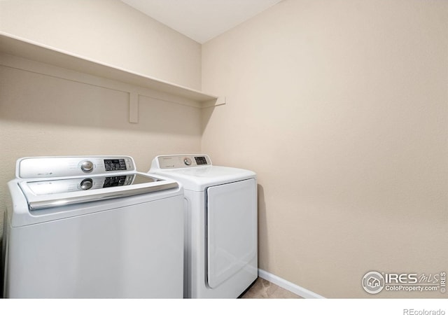 214 Tigercat Way, Fort Collins, CO 80524 - washroom with washer and clothes dryer, baseboards, and light tile patterned flooring
