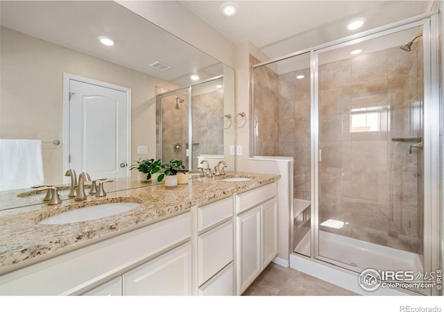 214 Tigercat Way, Fort Collins, CO 80524 - bathroom featuring a shower stall, double vanity, recessed lighting, and tile patterned floors
