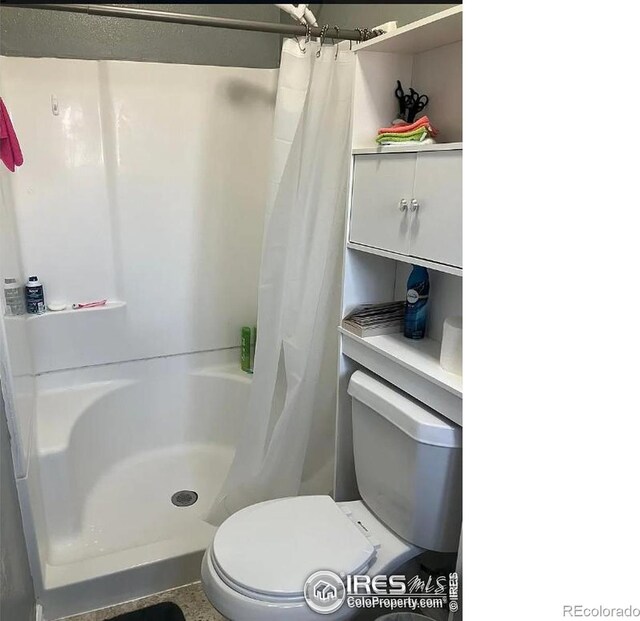 210 S Bowman Ave, Holyoke, CO 80734 - bathroom with curtained shower and toilet