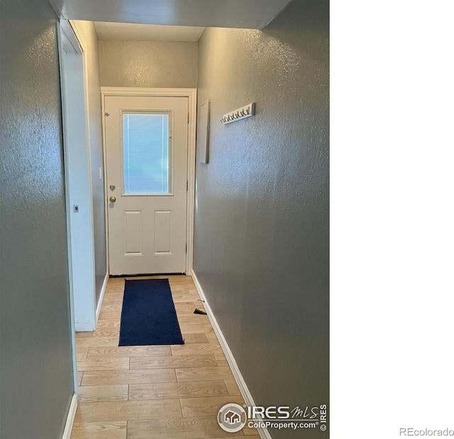 210 S Bowman Ave, Holyoke, CO 80734 - entryway featuring light wood-style flooring, baseboards, and a textured wall