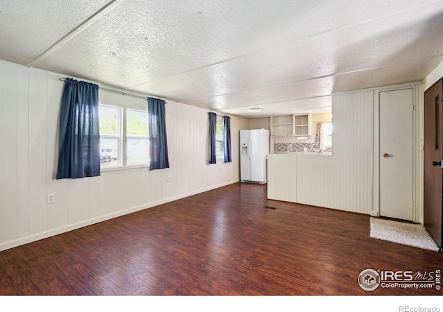 2812 Mango Pl, Loveland, CO 80537 - empty room featuring wood finished floors, a textured ceiling, and baseboards