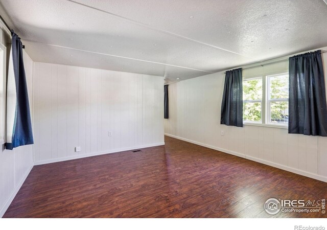 2812 Mango Pl, Loveland, CO 80537 - unfurnished room featuring wood finished floors, a textured ceiling, and baseboards
