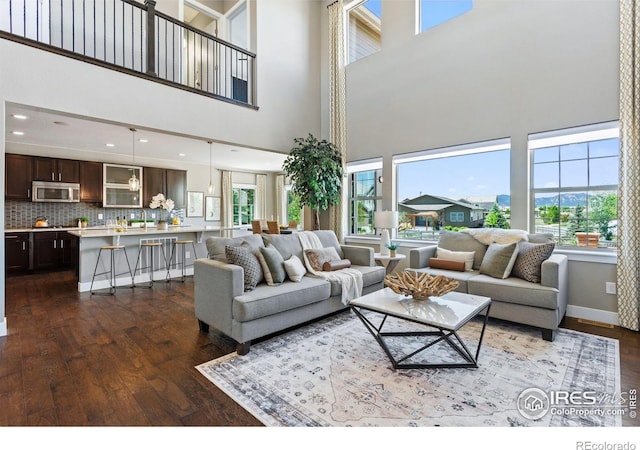 16069 Pikes Peak Dr, Broomfield, CO 80023 - living area with a high ceiling, dark wood-style floors, plenty of natural light, recessed lighting, and baseboards