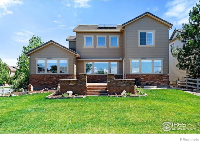 16069 Pikes Peak Dr, Broomfield, CO 80023 - view of front facade with roof mounted solar panels and stone siding