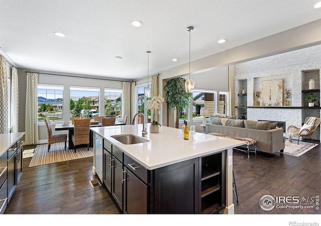 16069 Pikes Peak Dr, Broomfield, CO 80023 - kitchen with a sink, dark wood-style flooring, a fireplace, light countertops, and recessed lighting
