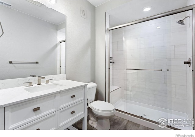 16069 Pikes Peak Dr, Broomfield, CO 80023 - bathroom with a shower stall, toilet, vanity, and recessed lighting