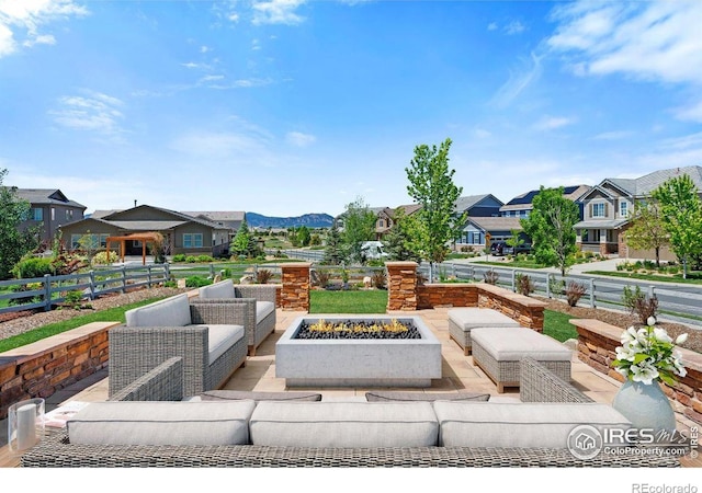 16069 Pikes Peak Dr, Broomfield, CO 80023 - view of patio with an outdoor living space with a fire pit, a residential view, and fence