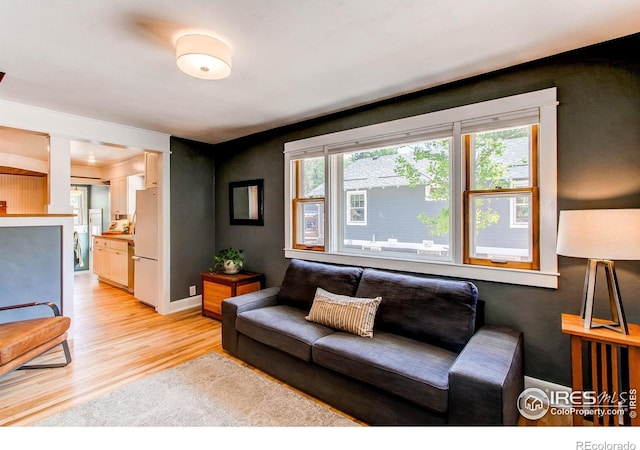 628 Endicott St, Fort Collins, CO 80524 - living area with light wood finished floors and decorative columns