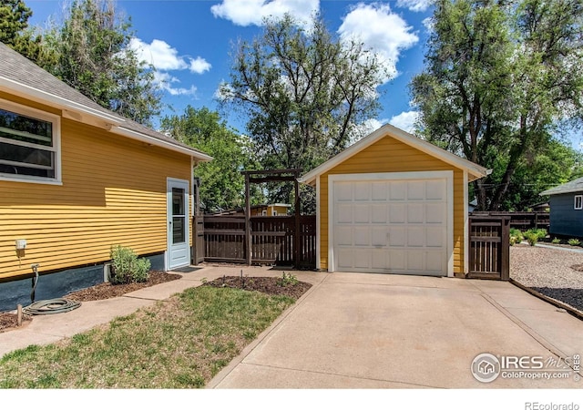 628 Endicott St, Fort Collins, CO 80524 - detached garage featuring driveway and fence