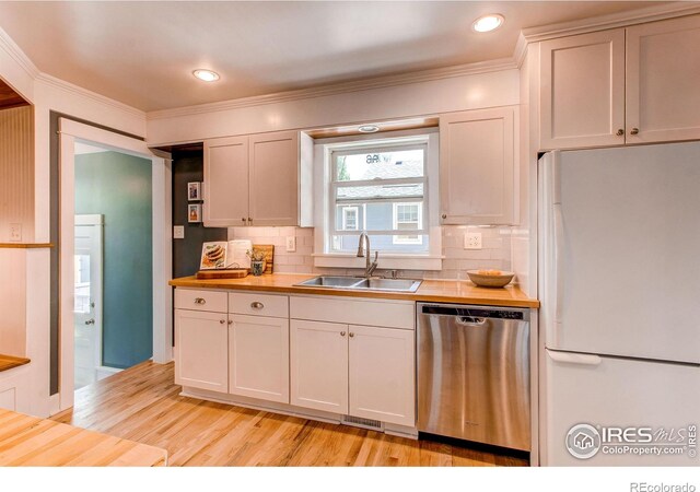 628 Endicott St, Fort Collins, CO 80524 - kitchen featuring freestanding refrigerator, dishwasher, a sink, wooden counters, and tasteful backsplash