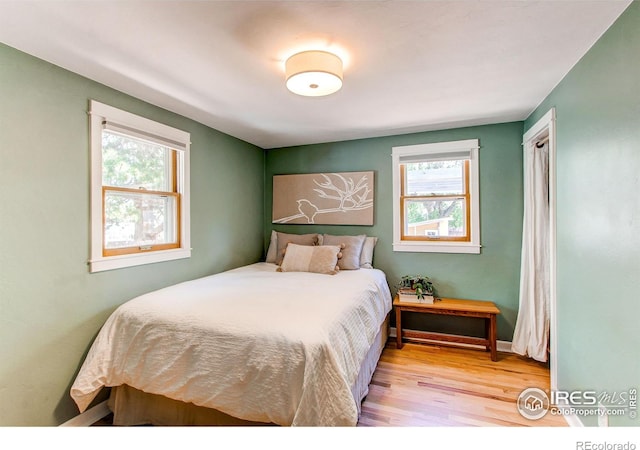 628 Endicott St, Fort Collins, CO 80524 - bedroom with multiple windows, wood finished floors, and baseboards