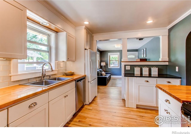 628 Endicott St, Fort Collins, CO 80524 - kitchen featuring butcher block countertops, a sink, freestanding refrigerator, dishwasher, and healthy amount of natural light