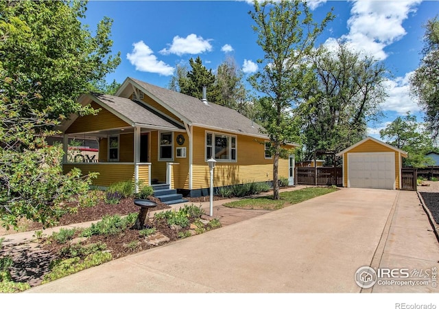 628 Endicott St, Fort Collins, CO 80524 - view of front of house with a porch, a garage, driveway, an outdoor structure, and fence