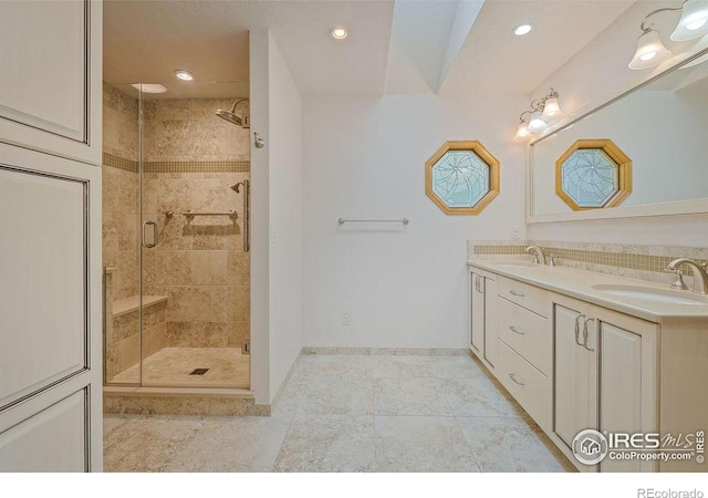 bathroom with a stall shower, recessed lighting, double vanity, baseboards, and tile patterned flooring