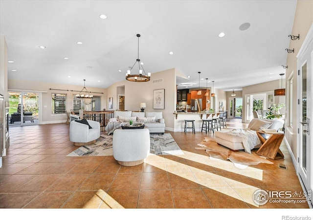 living area featuring light tile patterned flooring, a chandelier, recessed lighting, and baseboards