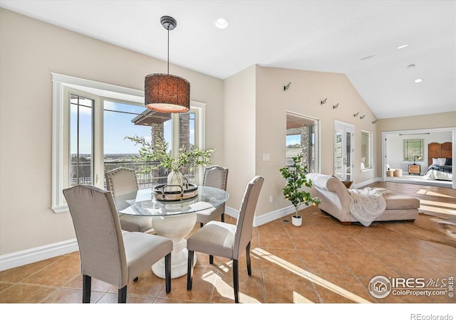 tiled dining room with vaulted ceiling, baseboards, and recessed lighting