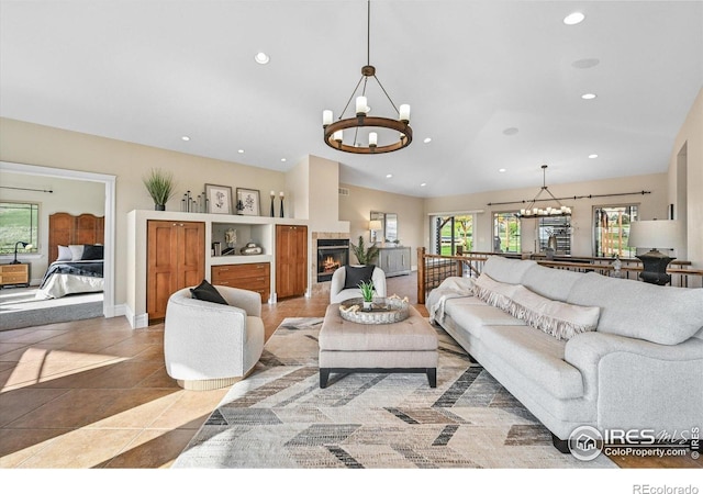 living room with a chandelier, recessed lighting, lofted ceiling, light tile patterned floors, and a fireplace