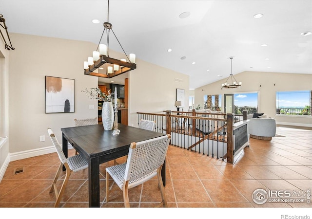 tiled dining room featuring a chandelier, vaulted ceiling, baseboards, and recessed lighting